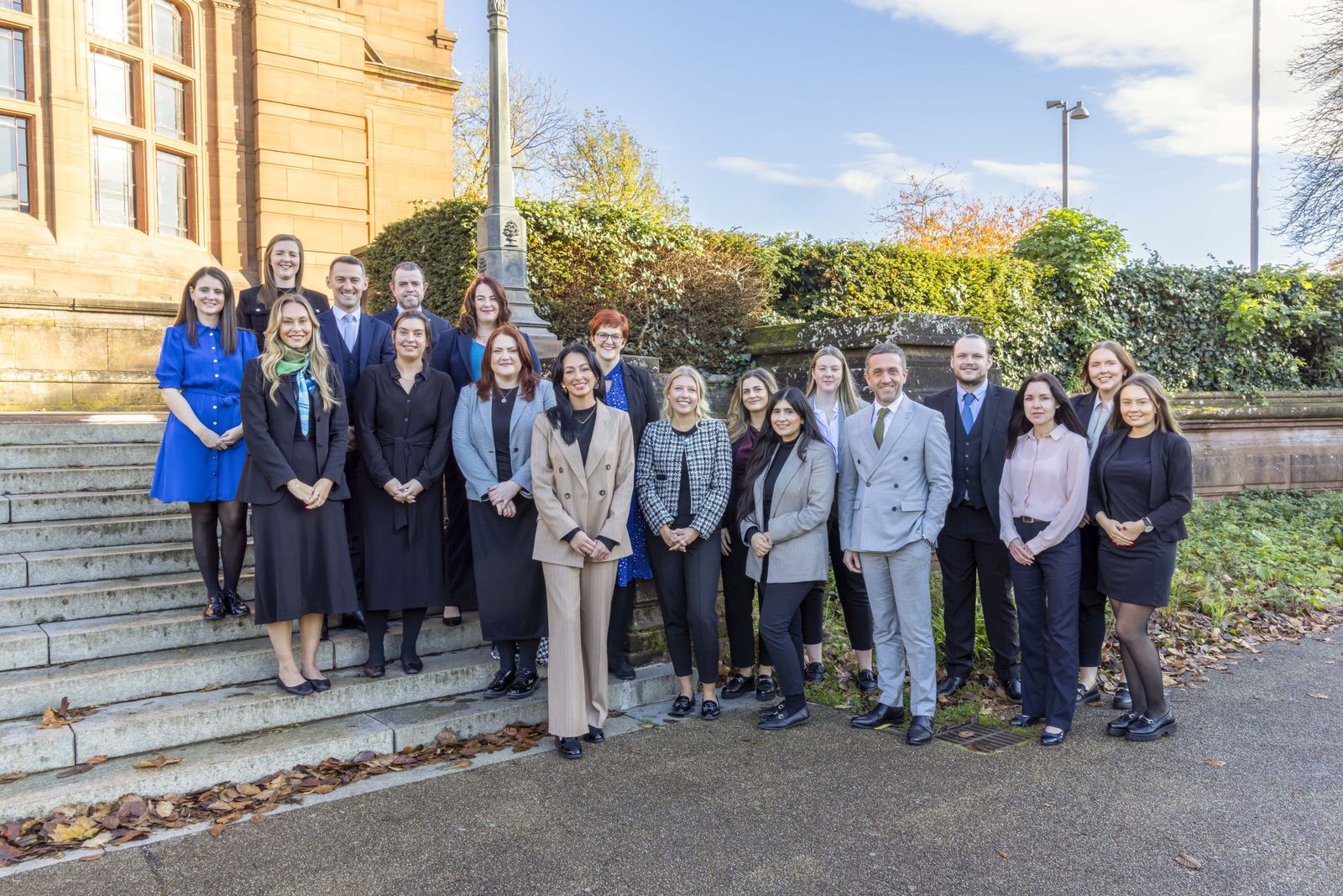 The Complete Clarity Solicitors team on the steps outside their Glasgow office